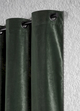 a green curtain hanging on a white wall