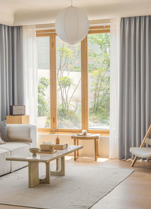 a living room filled with furniture and a large window