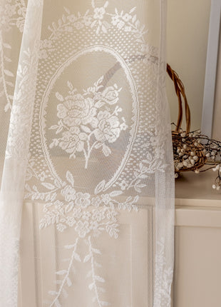 a white curtain with a flower design on it