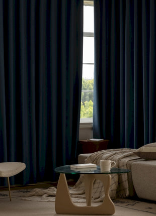 a living room with a couch, chair, coffee table and a window