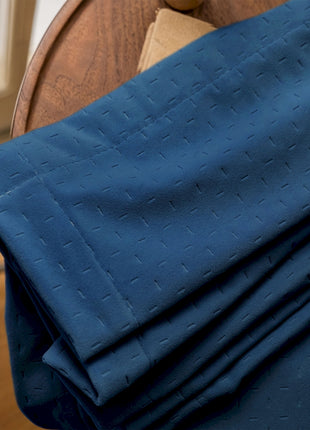 a close up of a blue cloth on a wooden chair