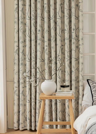 a bedroom with a bed and a window with curtains