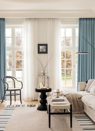 a living room filled with furniture and a large window
