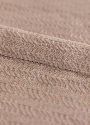 a close up of a blanket on a bed