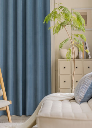 a living room with a white couch and a chair