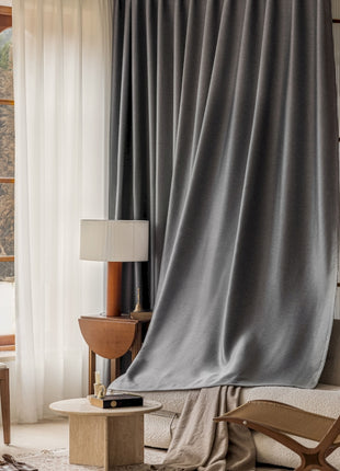 a living room with a chair and a window