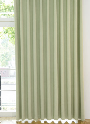 a room with a window and a green curtain