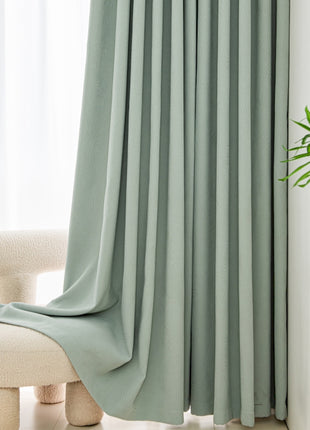 a white chair sitting in front of a window