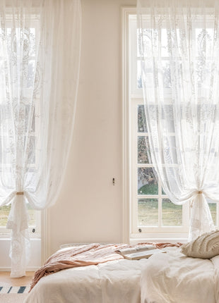 a bedroom with a bed and two windows