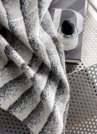 a black and white towel sitting on top of a table