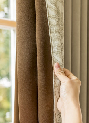 a hand is pulling the curtain off of a window