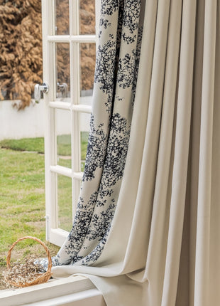 a window with a curtain and a basket on the window sill