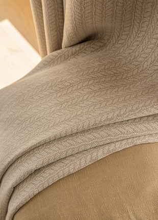 a close up of a bed with a comforter on top of it