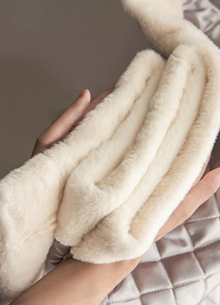 a woman's hand is holding a white blanket