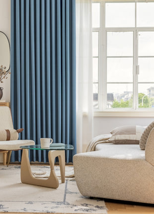 a living room filled with furniture and a large window