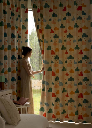 a woman standing in front of a window with a curtain
