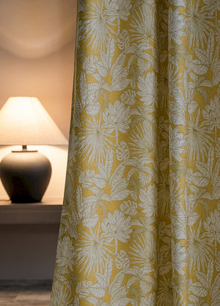 a lamp sitting next to a yellow curtain