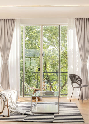 a living room filled with furniture and a large window
