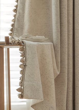 a window with a curtain and a table in front of it