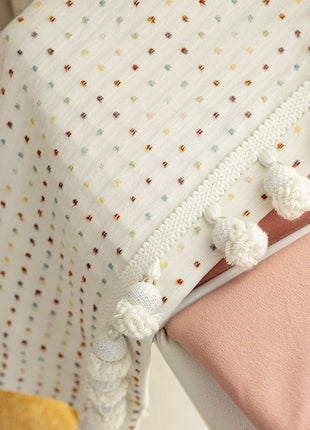 a crib with a blanket and pillow on top of it