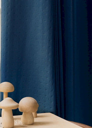 two mushrooms on a table in front of a window