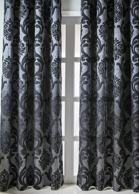 a living room with a chair and a window