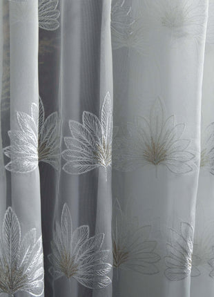 a close up of a curtain with white flowers on it