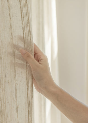 a person's hand is touching a wall with a window in the background