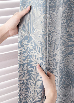 a person is pulling up a curtain with their hand