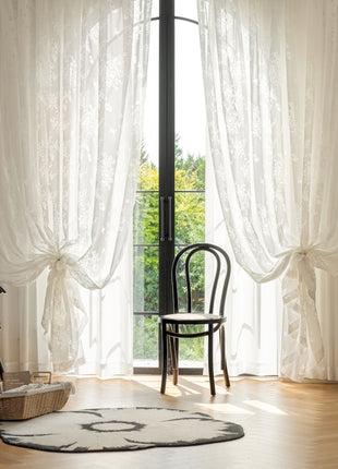 a living room with a chair and a rug