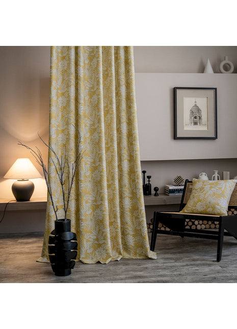 a living room with a chair and a curtain