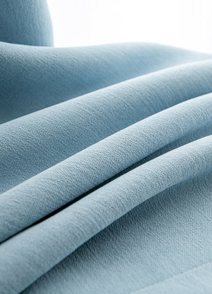 a close up of a light blue fabric