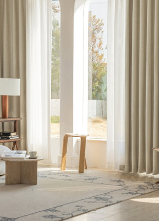 a living room filled with furniture and a large window