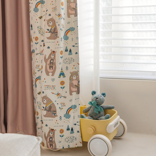 a teddy bear sitting in a wagon next to a window