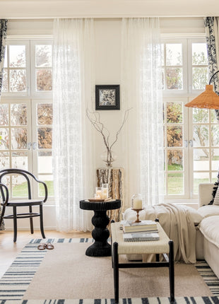 a living room filled with furniture and a large window