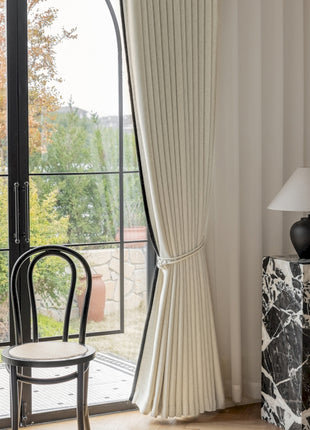 a room with a chair, table and a window