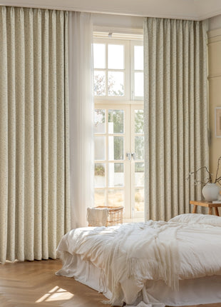 a bedroom with a large window and a white bed