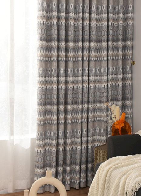 a living room filled with furniture and a window covered in curtains