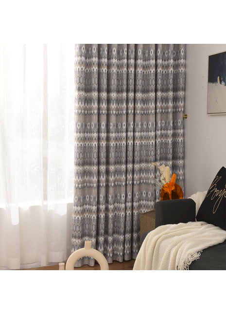 a living room filled with furniture and a window covered in curtains