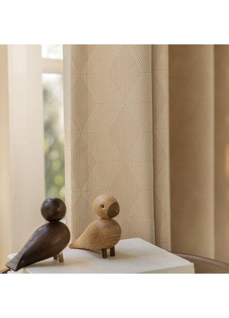 a couple of wooden birds sitting on top of a table