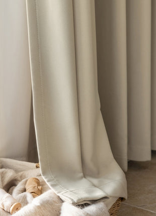 a stuffed animal laying on top of a blanket next to a window