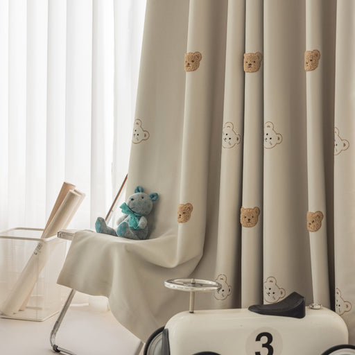 a teddy bear sitting on top of a toy car