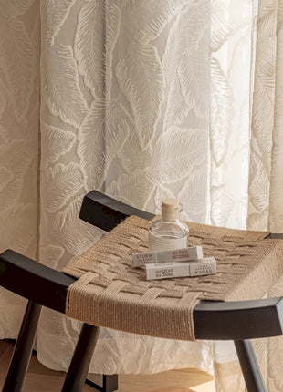 a chair and a table with a bottle on it