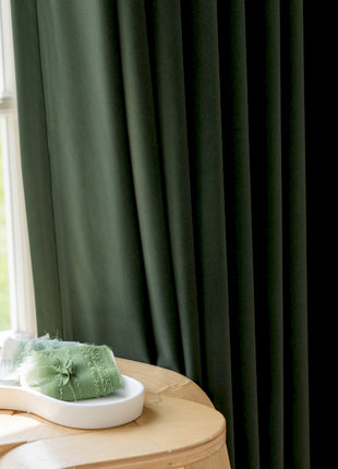 a wooden table topped with a bowl of green stuff