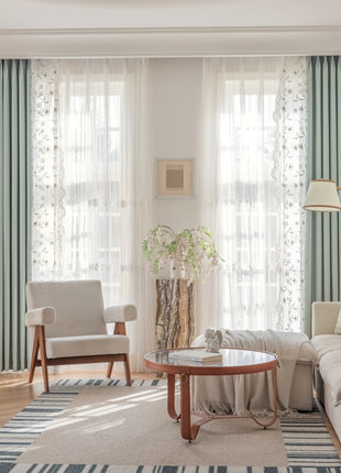 a living room filled with furniture and curtains