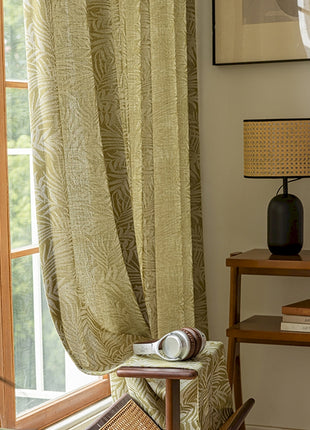 a living room with a chair and a window