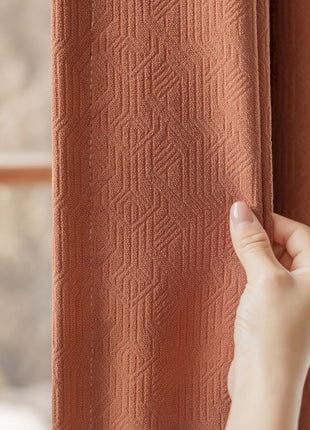 a hand is holding a curtain open to a window