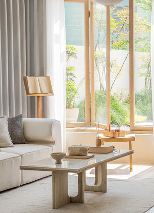 a living room filled with furniture and a large window