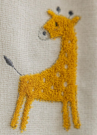 a close up of a giraffe embroidered on a piece of cloth