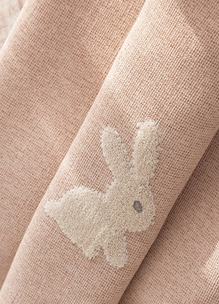 a close up of a curtain with a deer embroidered on it